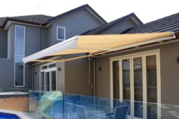 Awning over pool by Dynamic Outdoor Solutions