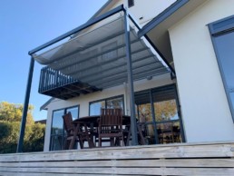 Outdoor entertaining setting with waveshade canopy